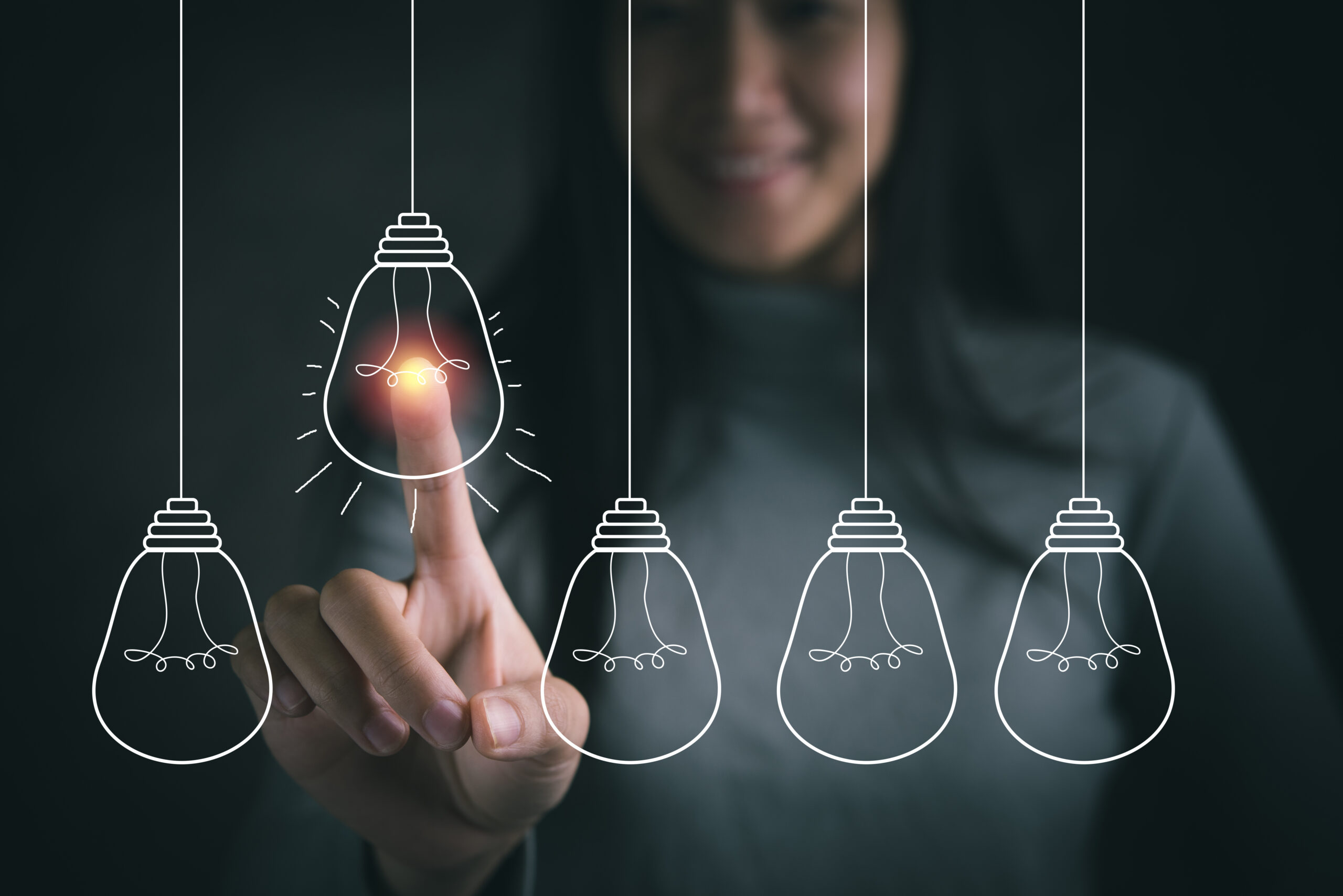 Businesswoman pointing light bulb